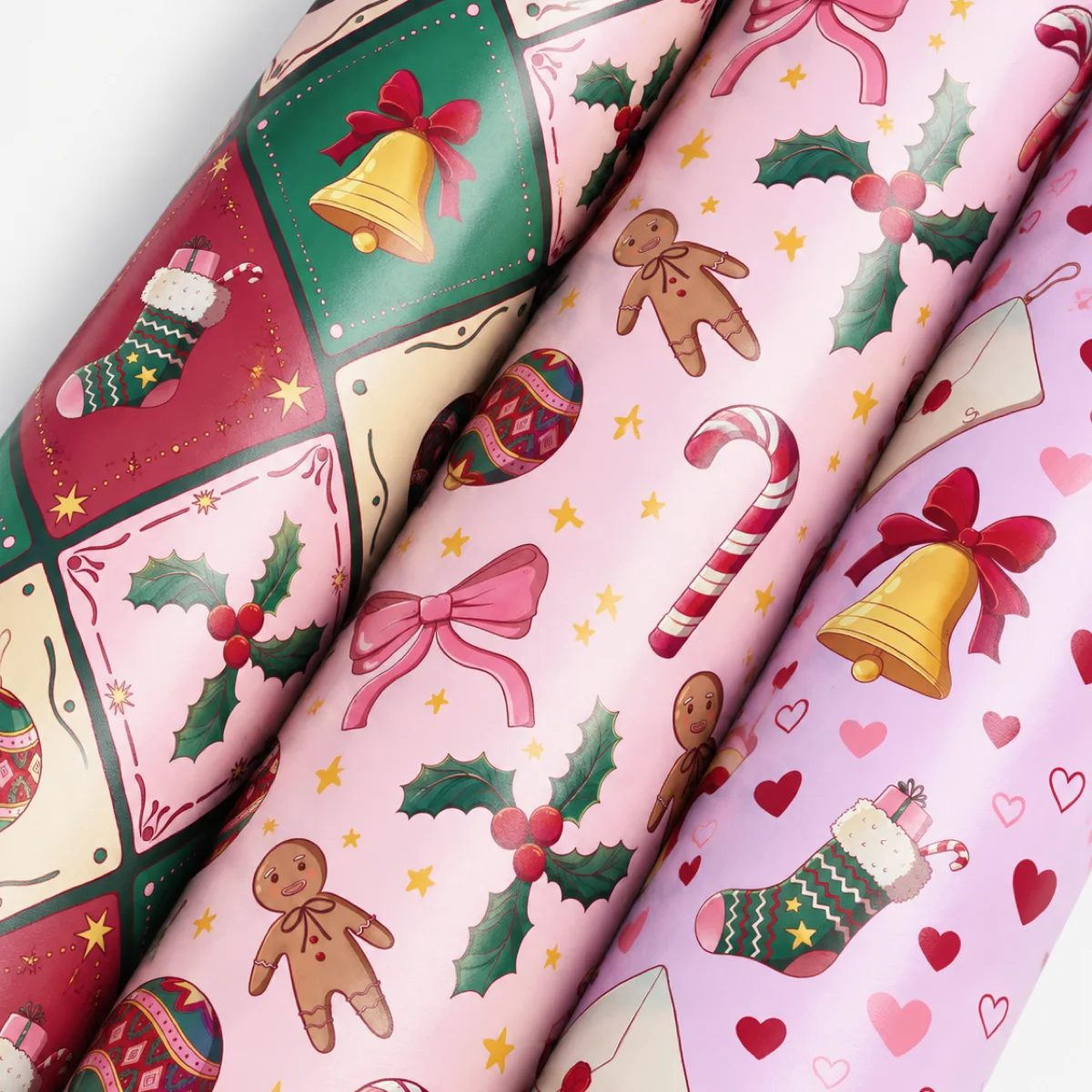 Close-up of three rolled Christmas wrapping paper designs in pink, red and lilac by Lizy Del Busto